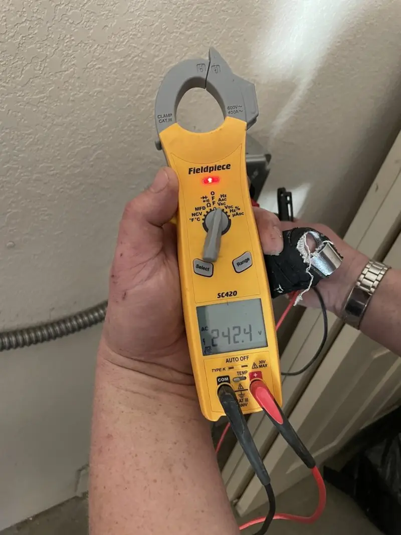 Voltage testing with clamp meter during Recessed Lighting Installation in Angleton